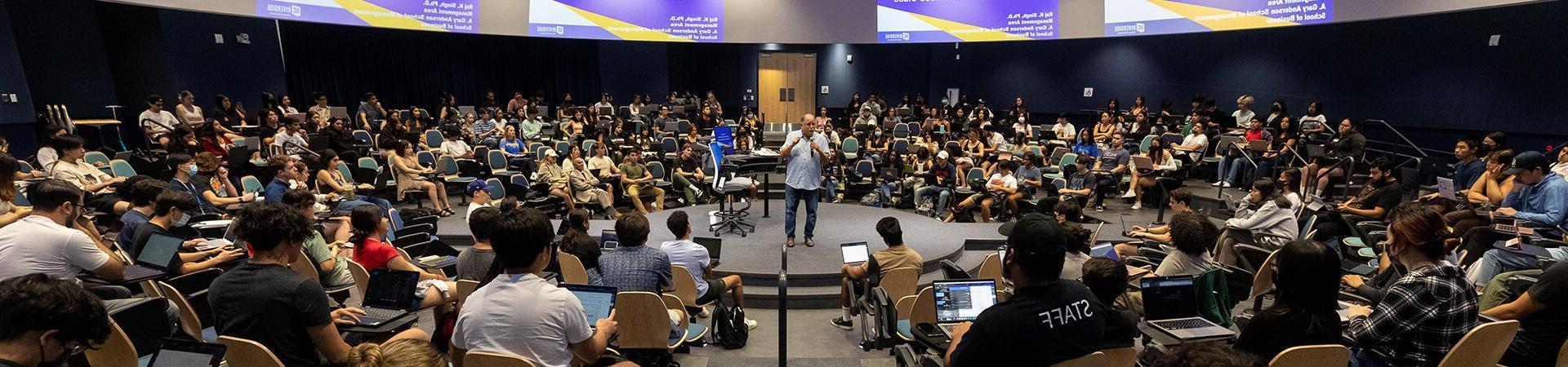 Assemblyman Jose Medina speaks to students in lecture hall at the Student Success Center